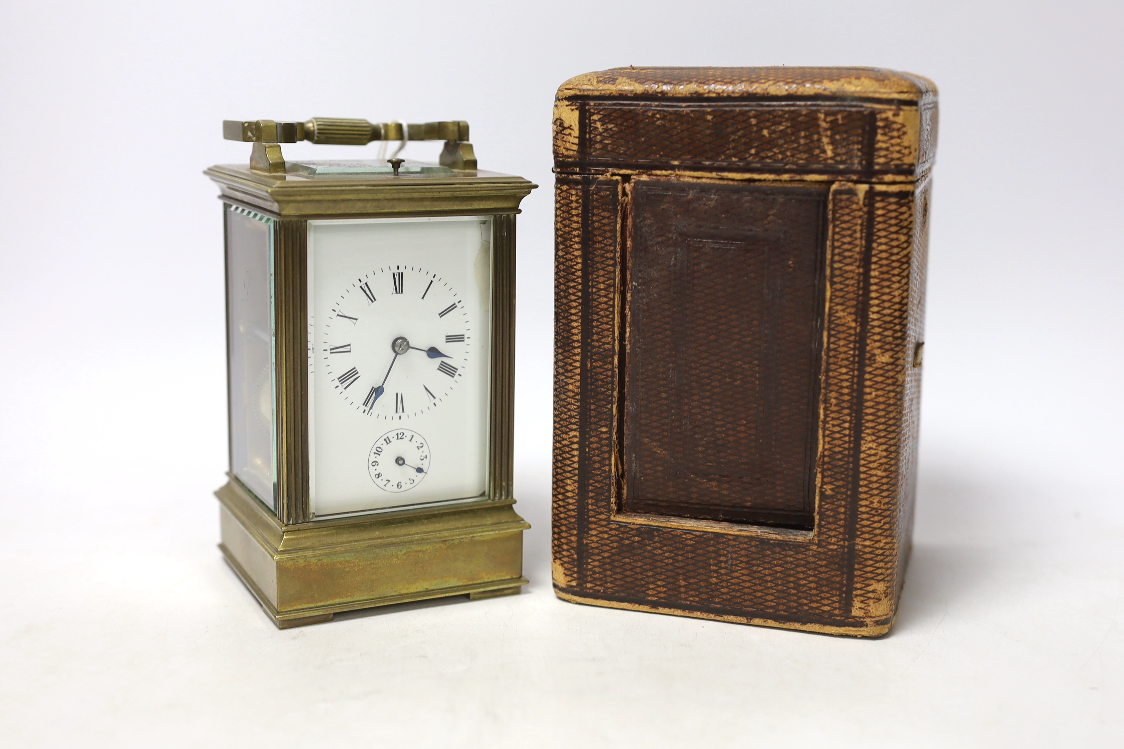 A cased early 20th century brass repeating carriage clock with alarm, 15.5cm